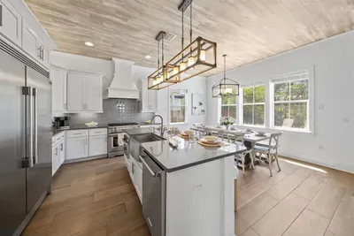 Four island stools, pendant lighting, and a kitchen built for the whole group — breakfast never looked so good.