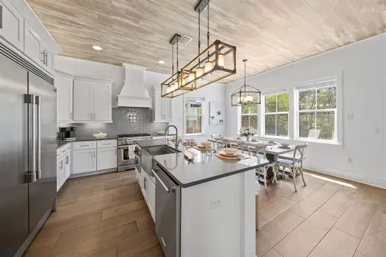 Four island stools, pendant lighting, and a kitchen built for the whole group — breakfast never looked so good.