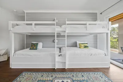 Built-in bunk beds for the kids — four twin beds, a 55" TV, and a space they'll never want to leave.