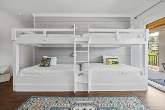 Built-in bunk beds for the kids — four twin beds, a 55" TV, and a space they'll never want to leave.