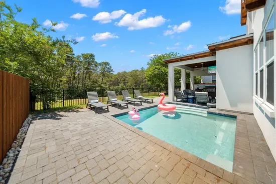 Four lounge chairs, a sparkling heated pool, and a fully fenced yard — perfect for kids, pets, and sunny afternoons.