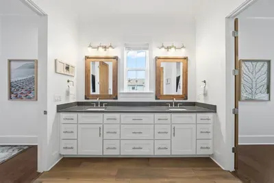 A beautifully appointed Jack and Jill bathroom shared between the two queen bedrooms — stylish and functional.