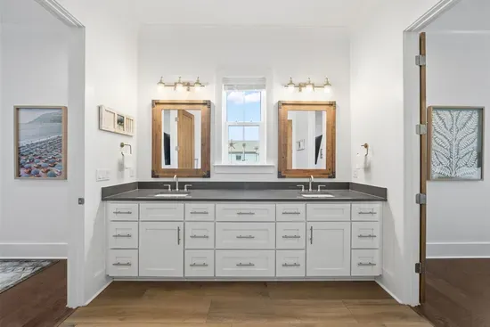 A beautifully appointed Jack and Jill bathroom shared between the two queen bedrooms — stylish and functional.