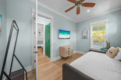 Ceiling fan, dresser, full length mirror, and a smart TV for winding down at the end of the day.
