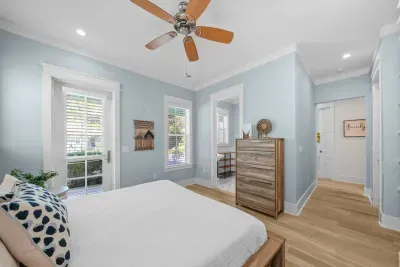 Another guest room with a ceiling fan and a full dresser, a few steps from the shared hall bath.