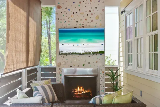 Screened porch with a smart TV, two ceiling fans, and cushioned seating. The best seat in the house when you want to be outside without the bugs.