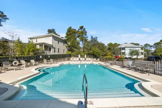 The neighborhood pool is a short walk from the front door, gated and quiet, with plenty of loungers when you want a break from the sand.