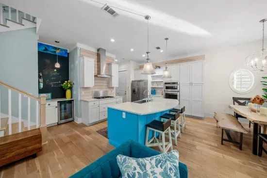 The main level runs from the island to the dining table to the sofa with no walls in between, and ten foot ceilings the whole way.