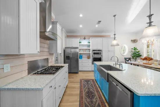 Gas cooktop, wall oven with built-in microwave, dishwasher, and a full size side-by-side refrigerator. Everything here to cook a real meal, not just reheat one.