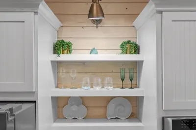 Open shelving keeps the glassware and plates within reach, so nobody has to hunt through cabinets.