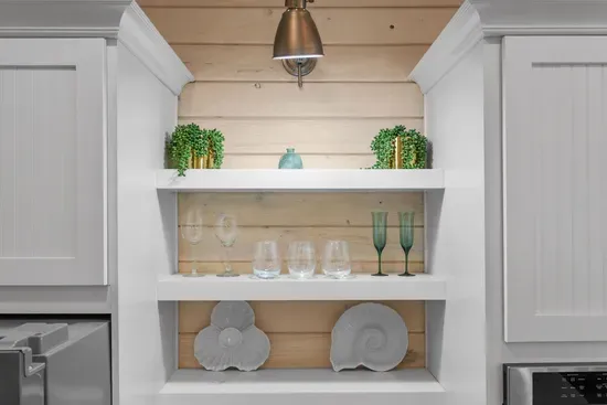 Open shelving keeps the glassware and plates within reach, so nobody has to hunt through cabinets.