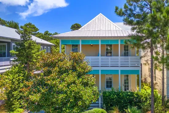 Two stories of porches and balconies, set back in the trees on a quiet street inside a gated neighborhood.