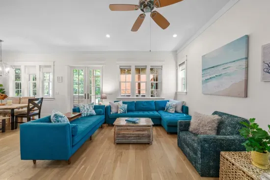 Two sofas plus extra chairs means nobody ends up sitting on the floor when the whole group is in.