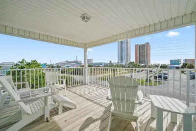 Spacious, covered walk-out balcony on the Unit B side with Adirondack seating. Perfect for morning coffee, evening cocktails, or relaxing coastal breezes while overlooking the surrounding area.