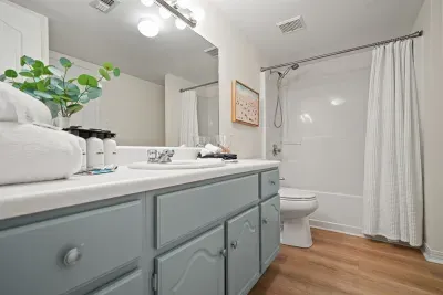 Unit A main-level bathroom featuring a tub/shower combo and spacious vanity. Conveniently connected to the main-level bedroom and also accessible from the main living area.