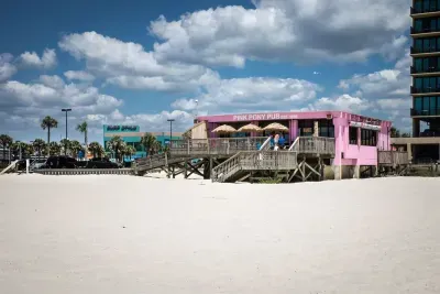 Live music, ocean views, and cold drinks at The Pink Pony Club — all just a short 10-minute stroll from your stay.