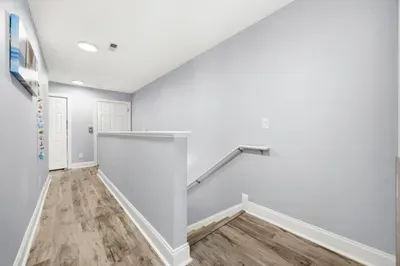 Looking out the primary bedroom with stairs going down to 2nd floor