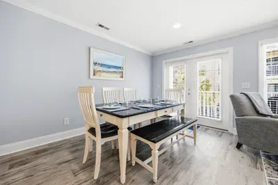Dining room table with bench seat, looking out to the balcony