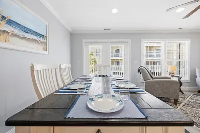 Dining room table with bench seat looking out to the balcony