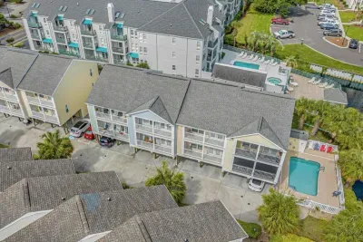 Aerial view of unit (blue exterior) and of the pool