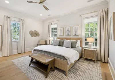 Wake up to sunlight on both sides of the bed. The serene primary suite pairs a king bed and luxe linens with calm, coastal style.