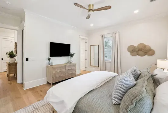 Sink into layered, luxe bedding at the end of a beach day. A mounted smart TV makes this room a cozy escape of its own.