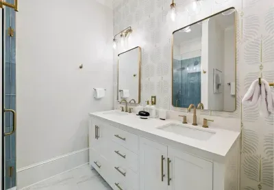 Spa-quality finishes throughout — quartz counters, bronze hardware, and hand-laid tile that turn a quick rinse into a treat.