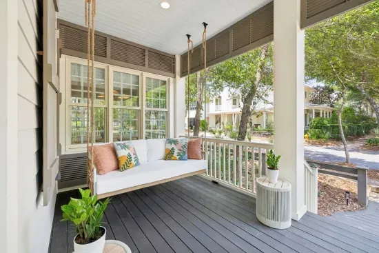 Sway the afternoon away — the covered front porch catches the breeze and the gentle rhythm of WaterColor life.