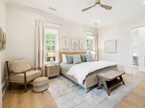 Retreat to the primary suite — a plush king bed, a quiet reading chair, and a private ensuite bath just steps away.