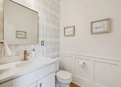 A stylish powder room on the main floor — handy for guests and quick clean-ups between the beach and the table.