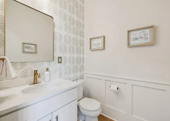 A stylish powder room on the main floor — handy for guests and quick clean-ups between the beach and the table.