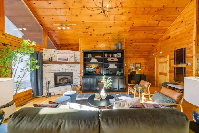 Bright living room featuring a TV and a cozy fireplace.