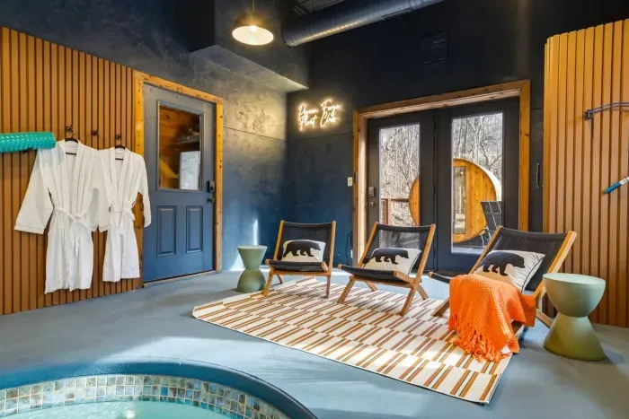 Lower-level pool room with direct access to a deck featuring a private barrel sauna.