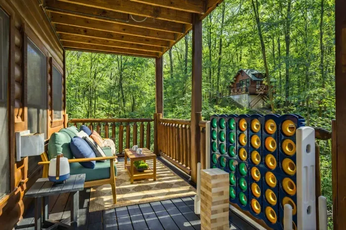 Mid-level deck featuring outdoor speakers, Jumbo Jenga, and Connect 4 to enjoy with your kids.