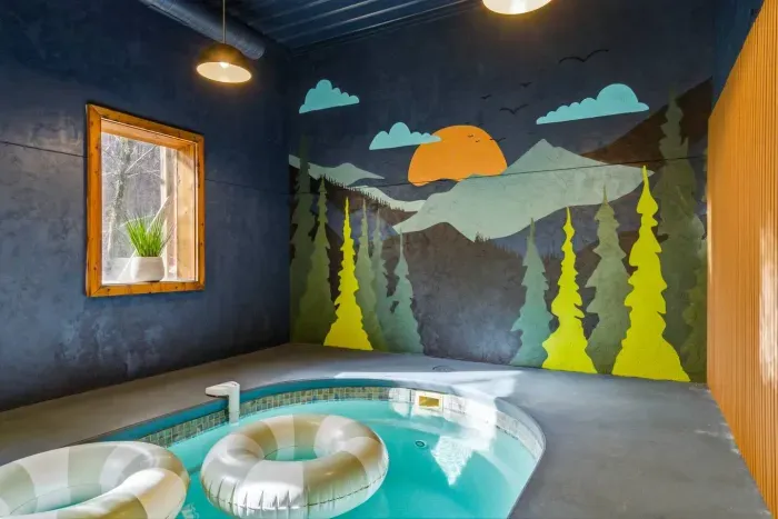 Beautiful Smoky Mountain mural in the pool room.  Please note that flotation devices in the pool for illustrative purposes only. They are not provided. Guests are welcome to bring their own if desired.