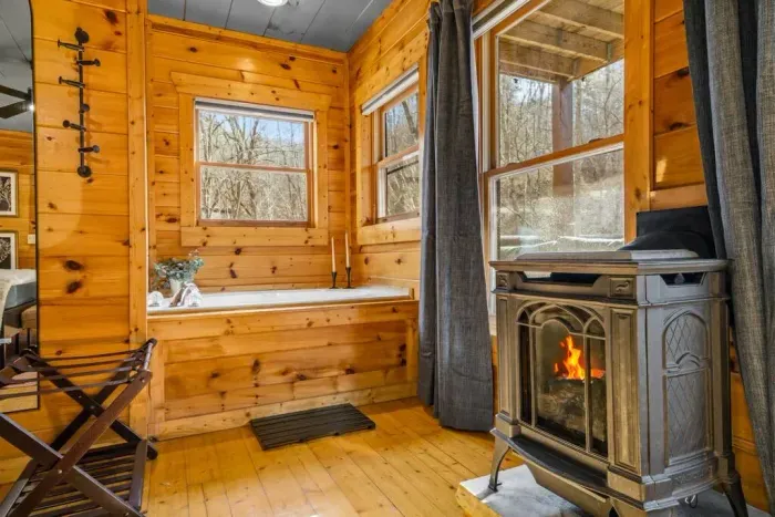 Unwind in the bedroom with a cozy fireplace and private Jacuzzi tub.