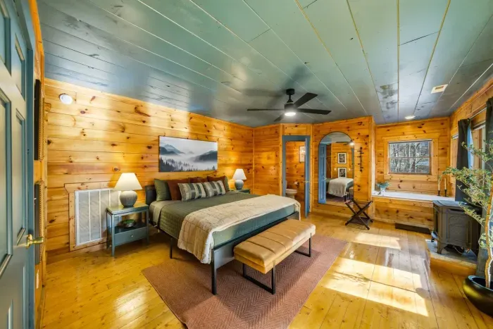 Spacious mid-level king bedroom featuring a private Jacuzzi tub.
