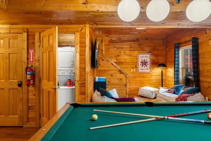 Washer and dryer, along with an iron, are conveniently located in the game room area.