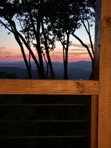 Rustic deck with stunning sunset mountain views through the trees
