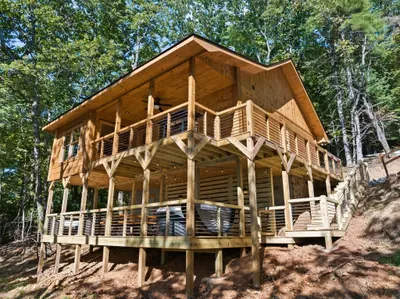 Secluded hillside cabin with wraparound decks and forest views