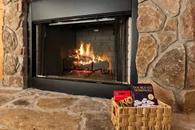 Cozy stone fireplace with games for relaxing nights in
