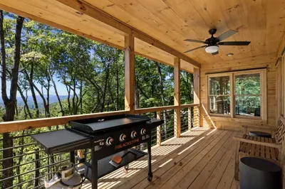 Private covered deck with Blackstone grill and serene mountain views