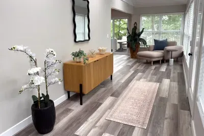 Sunroom off the living room space with board games in cabinets