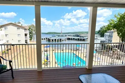 Covered porch overlooking the pool and lake