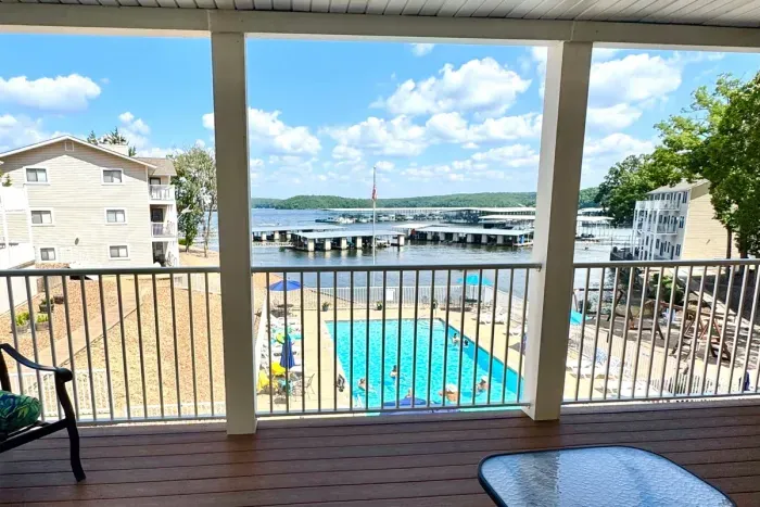Covered porch overlooking the pool and lake