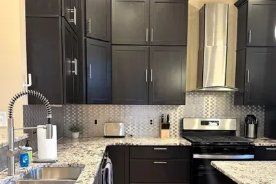 Granite counters in kitchen with newly finished cabinets