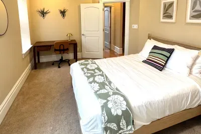Queen bed with work desk in guest bedroom #2