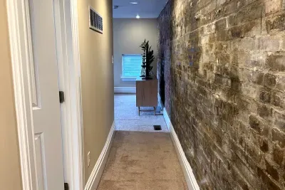 Entry to primary suite with historic exposed brick