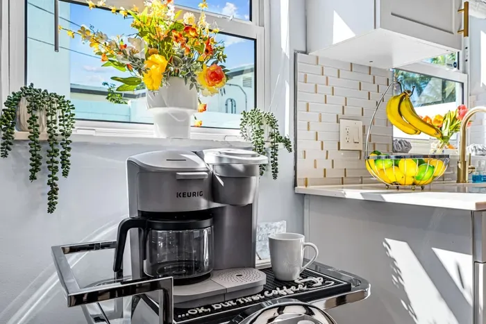 Who is ready for their cup of coffee in this beautiful kitchen? How about taking it outside to the outdoor dining table or perhaps relaxing on a sun lounger.