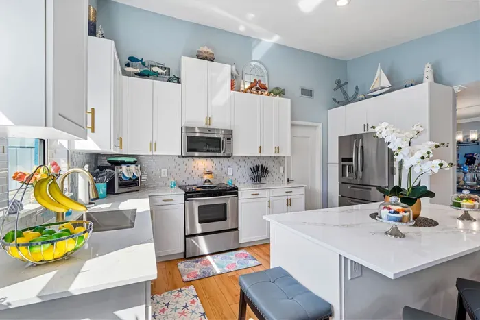 Modern cooking appliances and spacious quartz countertops, the kitchen has it all!
